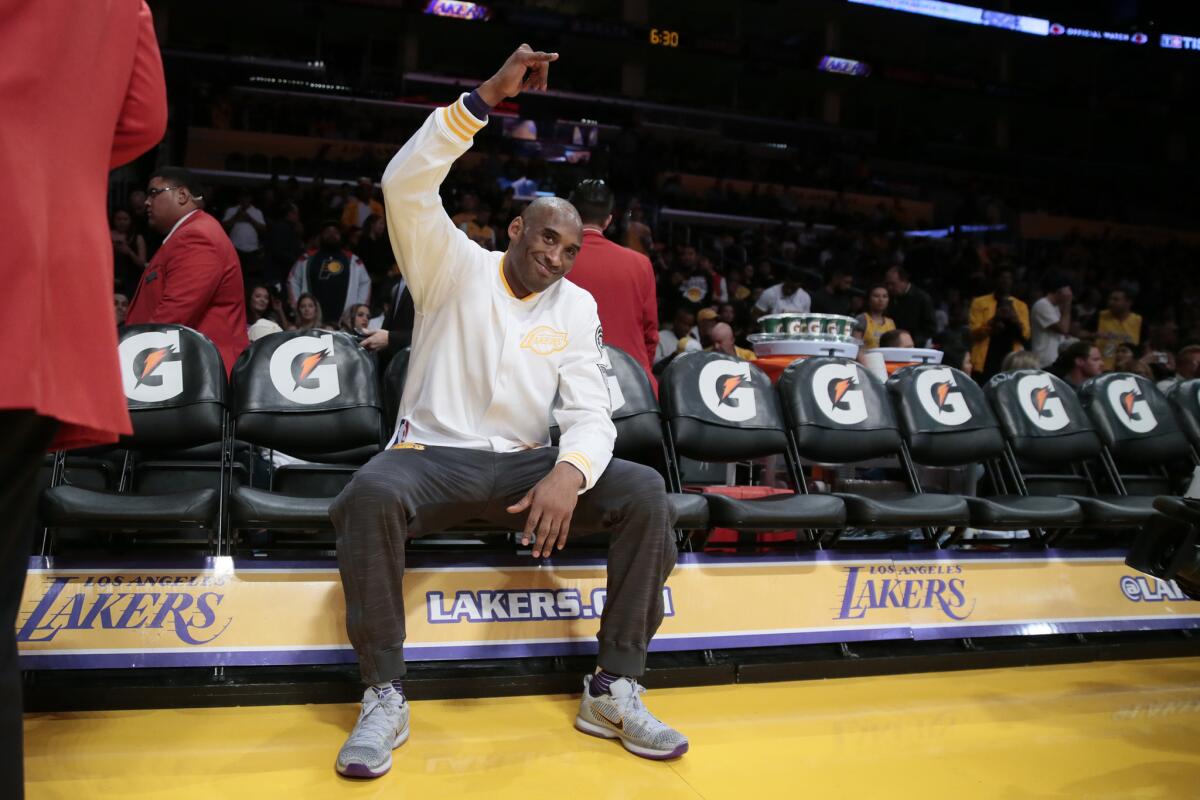 Lakers star forward Kobe Bryant waves to fans during warmups before a game against the Pacers.