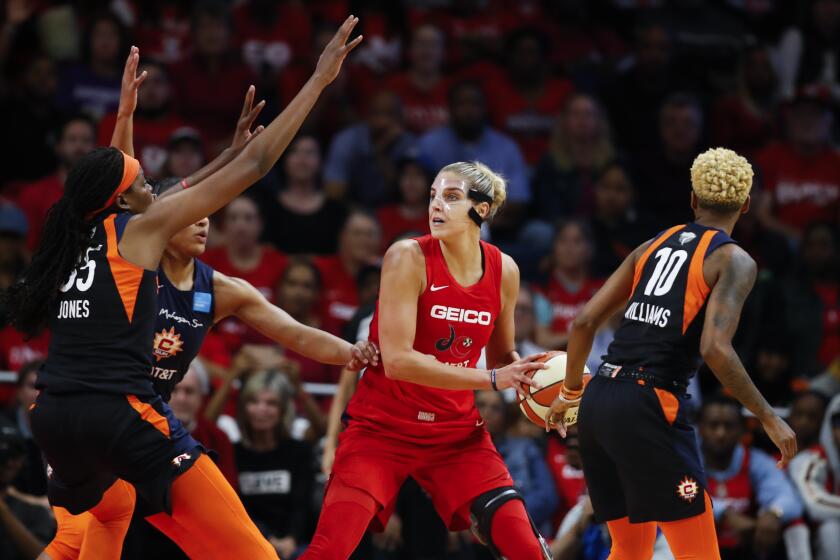 FILE - In this Oct. 10, 2019, file photo, Connecticut Sun forward Jonquel Jones, left, and guard Courtney Williams, right, huard Washington Mystics forward Elena Delle Donne during the first half of Game 5 of basketball's WNBA Finals in Washington. Delle Donne is waiting to have her case heard by the league's independent panel of doctors to see if she'll be medically excused for the season, according to the Mystics. The Mystics star, who was the league Most Valuable Player last year, has battled Lyme Disease since 2008 and would potentially be at a higher risk for serious illness if she contracted the new coronavirus. (AP Photo/Alex Brandon, File)