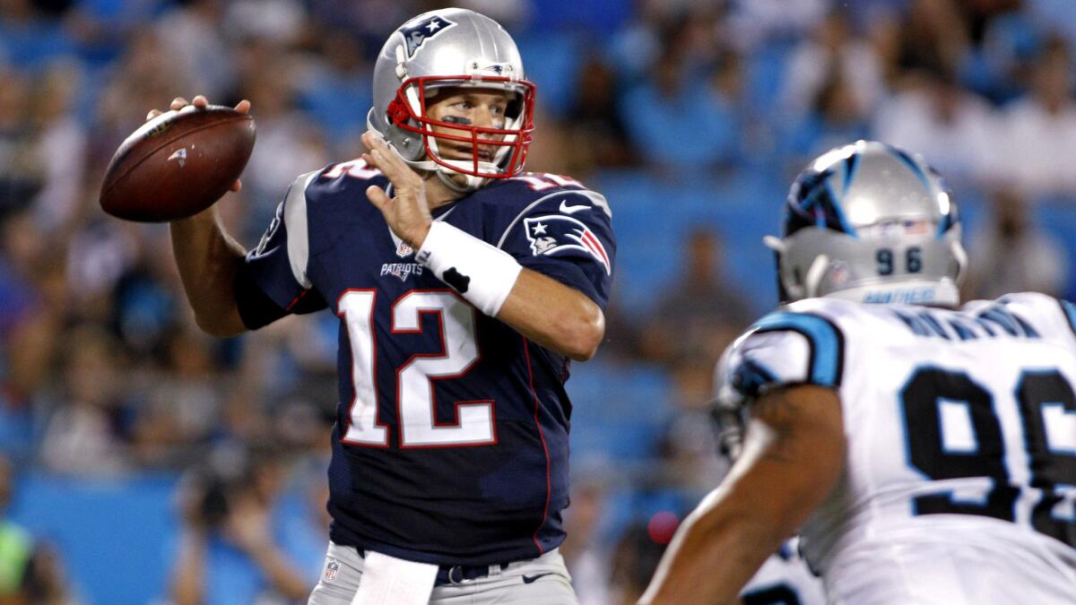 Patriots quarterback Tom Brady (12) looks to pass under pressure from Panthers defensive end Wes Horton in the first half of a preseason game Friday night in Charlotte, N.C.