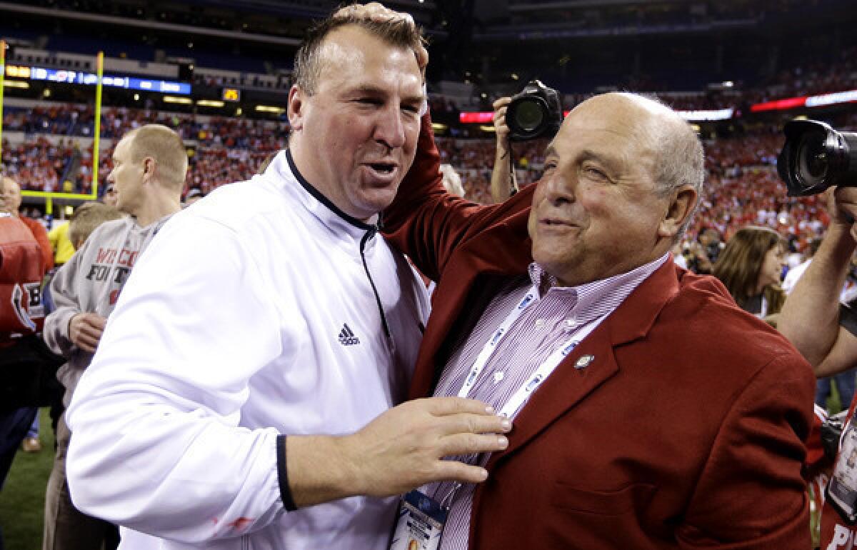 Outgoing Wisconsin Coach Bret Bielema, left, is congratulated by Athletic Director Barry Alvarez after winning the Big Ten Conference championship game over Nebraska.