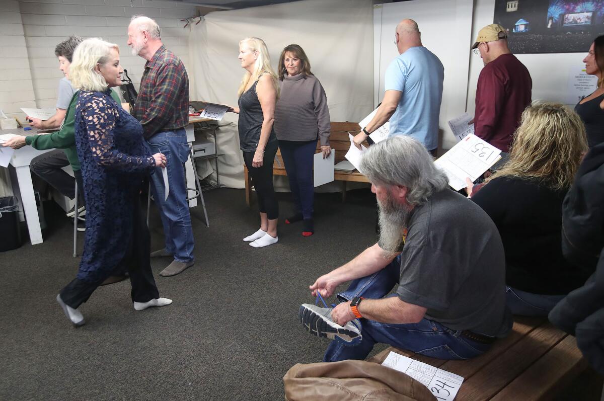 Pageant of the Masters cast hopefuls line up to have their picture taken at the Festival of Arts grounds on Jan. 5.