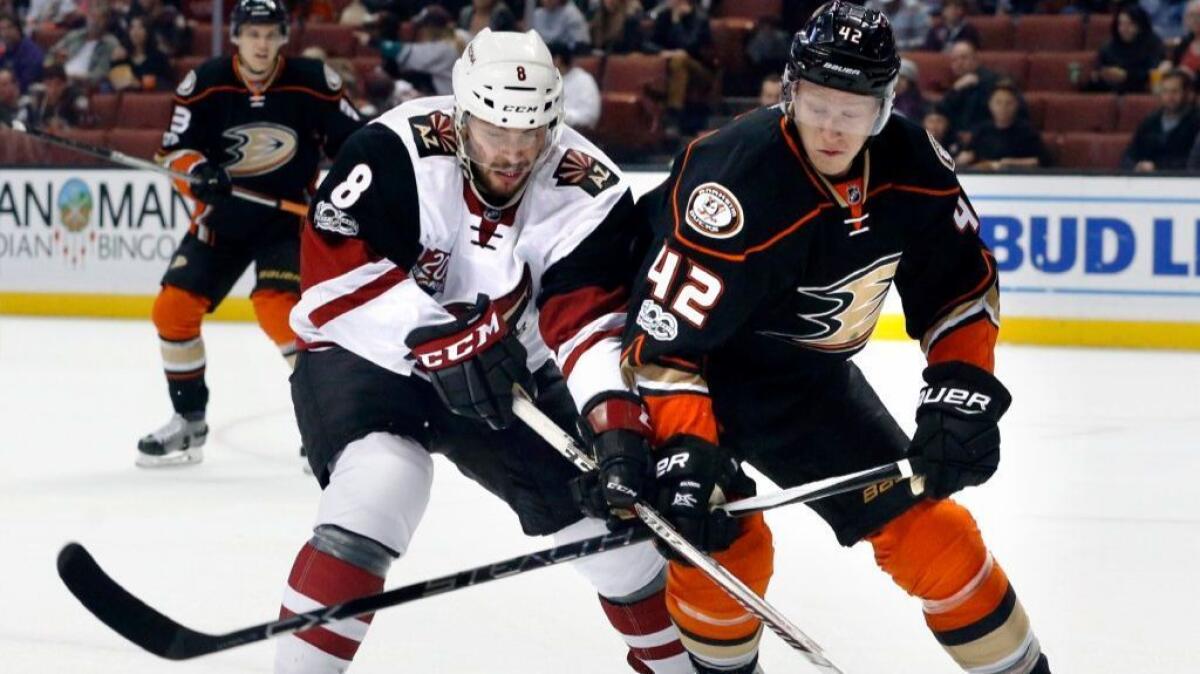 Coyotes forward Tobias Rieder and Ducks defenseman Josh Manson battle for the puck in the first period of a game on Jan. 6.