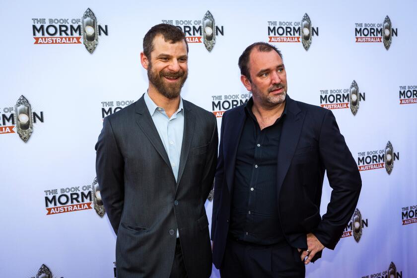Two men in suits pose upon arrival at a premiere in Australia
