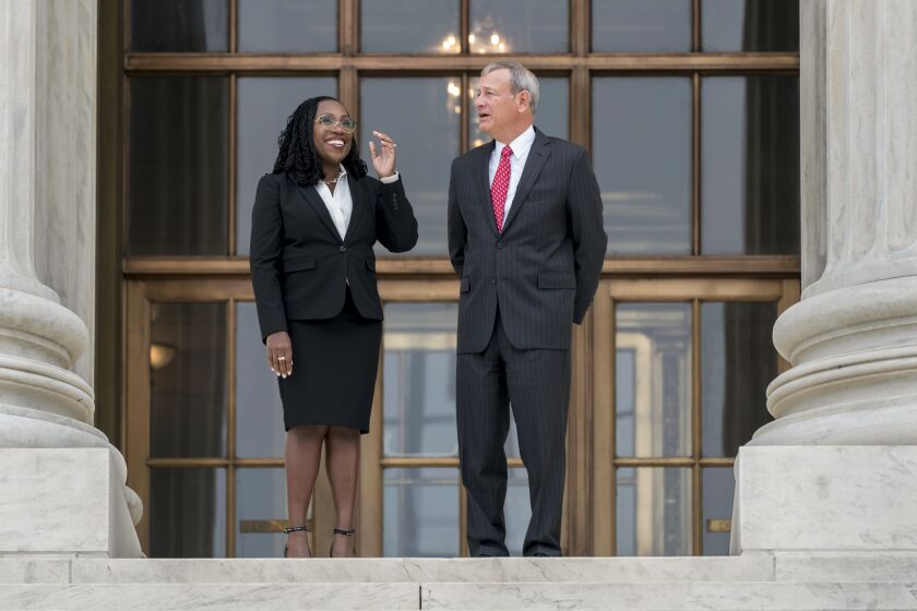 Justice Ketanji Brown Jackson, left, is escorted by Chief Justice of the United States John Roberts following her formal investiture ceremony at the Supreme Court in Washington, Friday, Sept. 30, 2022. (AP Photo/J. Scott Applewhite)