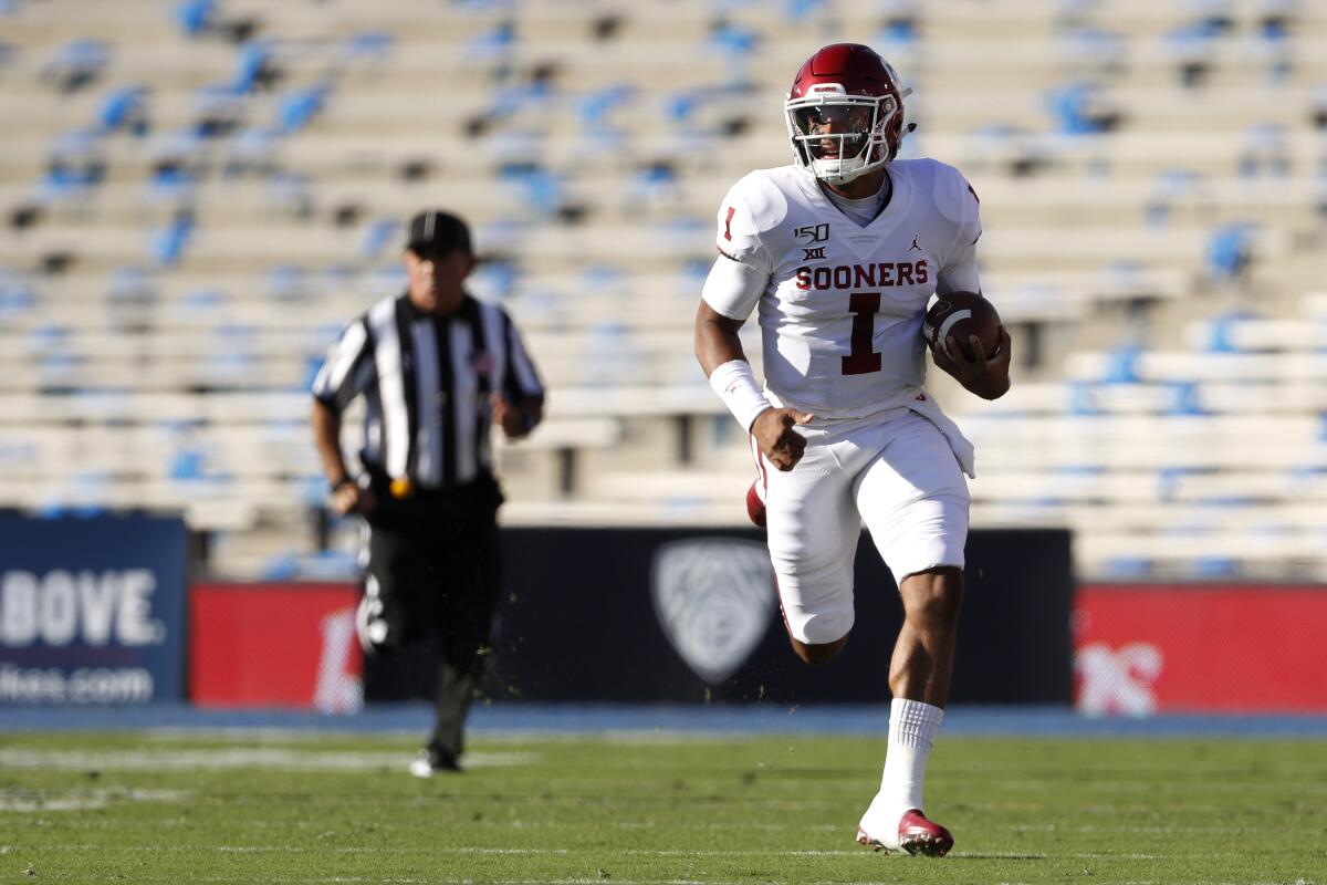 Oklahoma quarterback Jalen Hurts sprints with the ball in front of a plethora of open seats at the Rose Bowl on Saturday.