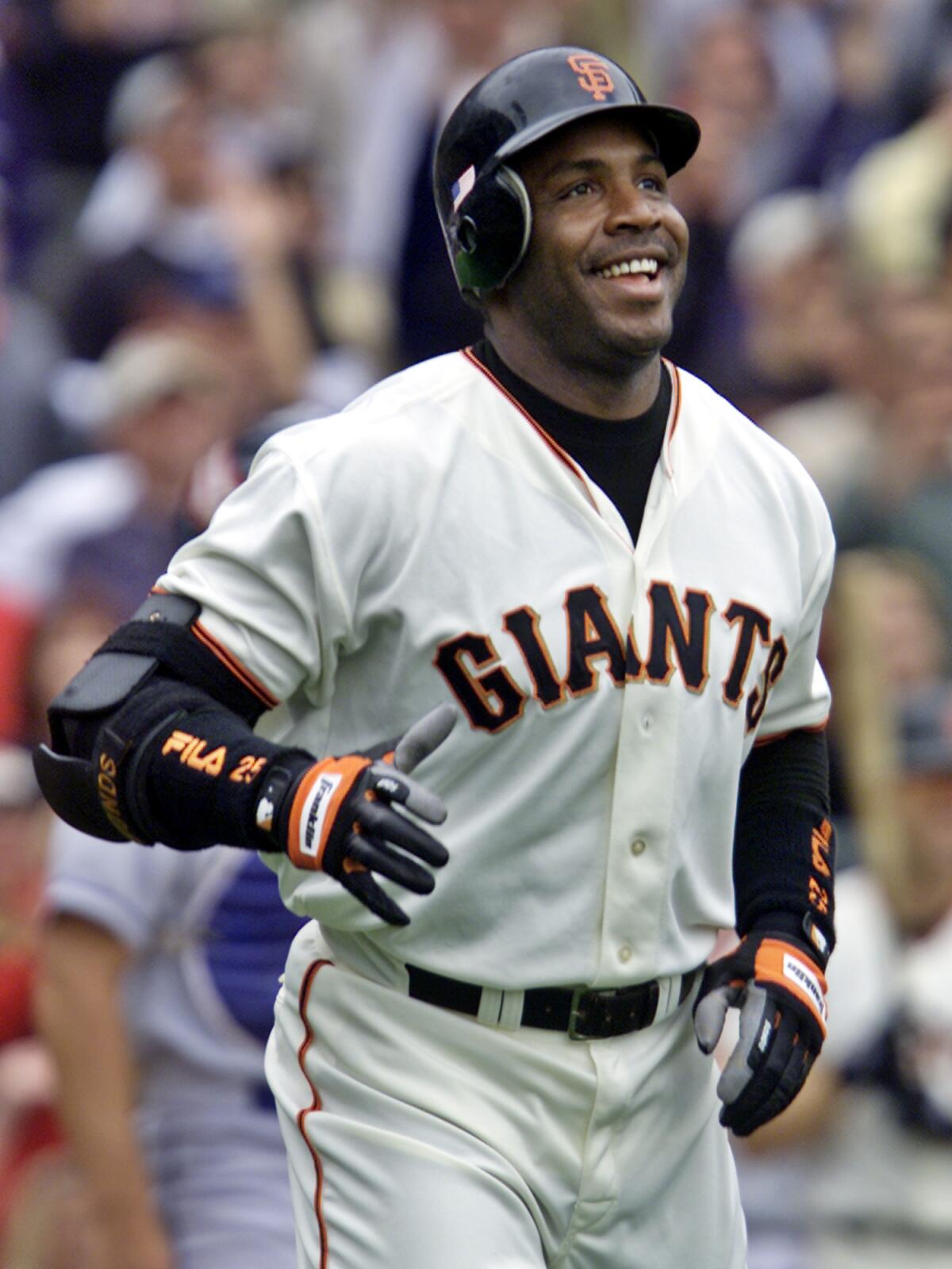 San Francisco's Barry Bonds smiles as he begins to round the bases after hitting his 73rd home run of the season.