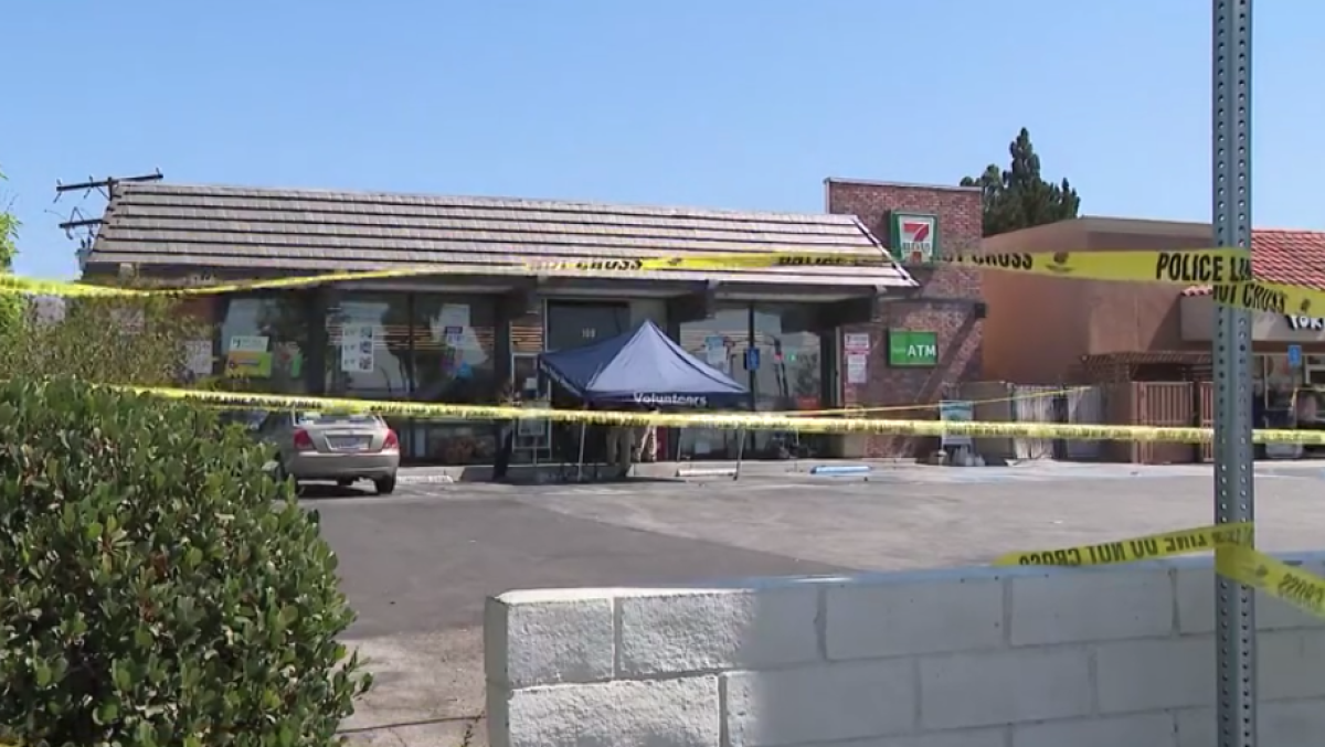 A generic strip mall with police tape around its perimeter