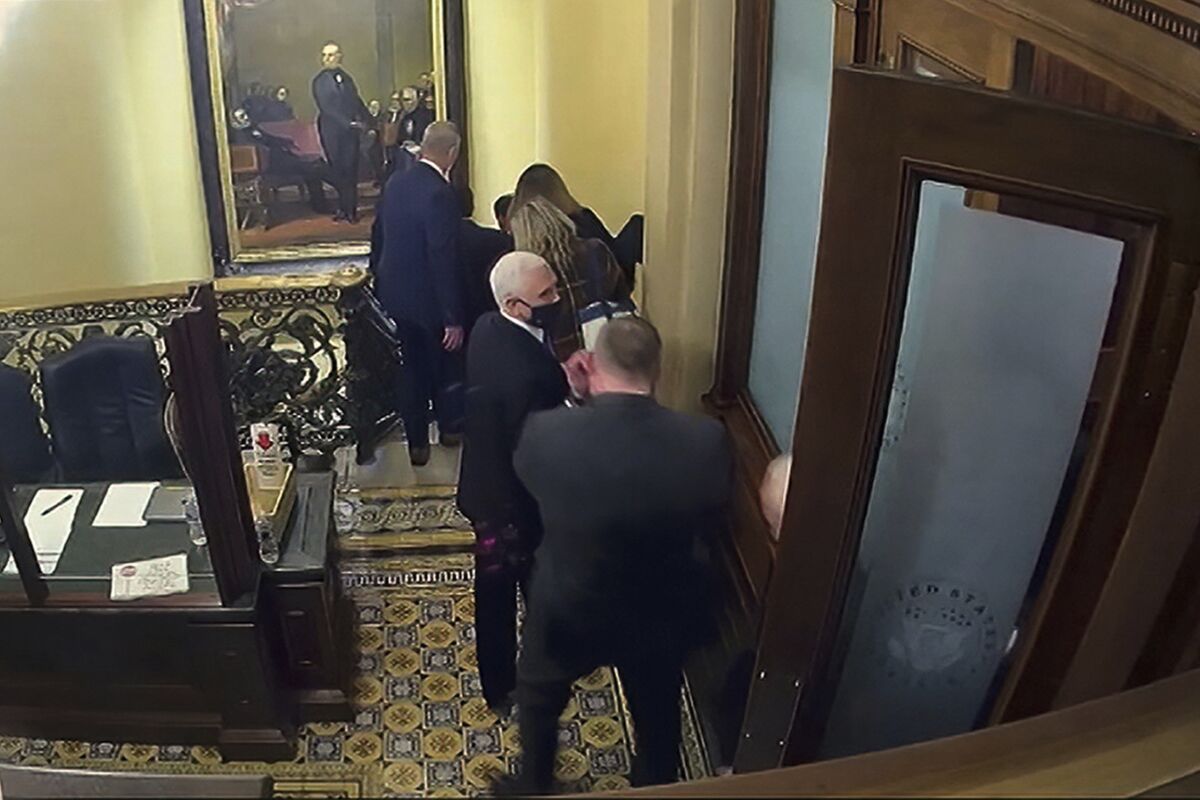 Vice President Mike Pence being evacuated from near the Senate chamber as rioters breach the Capitol, on Jan. 6, 2021.