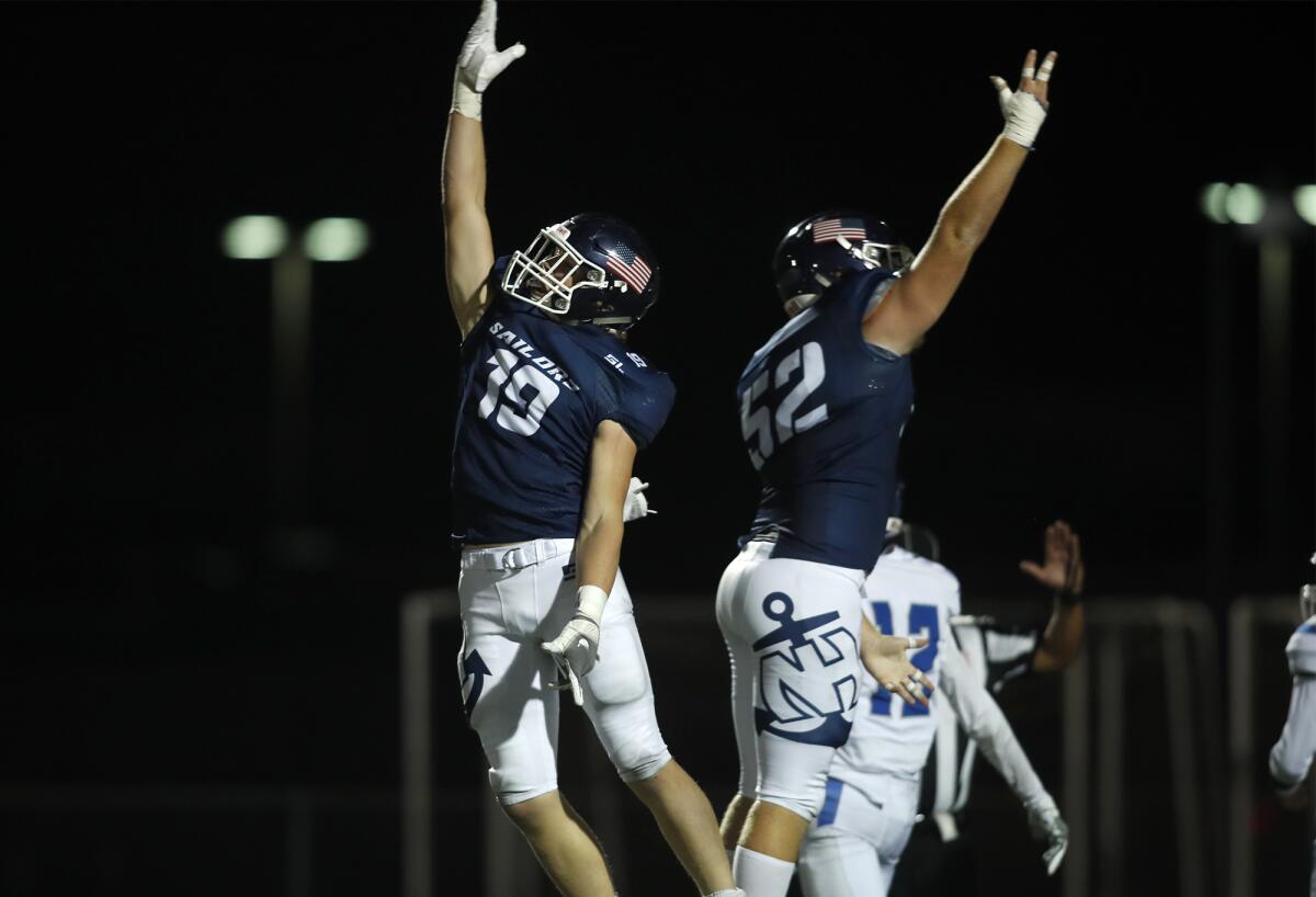 Aidan Goltz, left, celebrates his 22-yard touchdown catch for Newport Harbor with offensive lineman Carter Mathisrud during the first quarter of a nonleague home game against San Marino on Friday at Davidson Field.