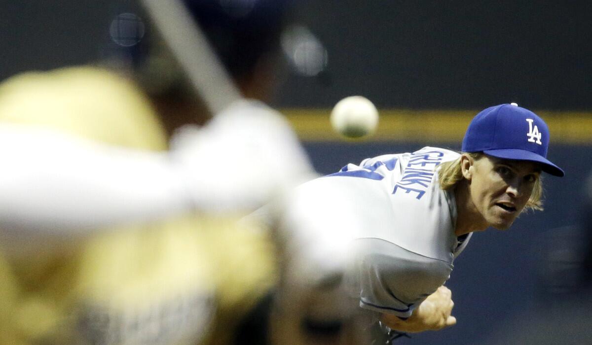 Dodgers starting pitcher Zack Greinke throws during the first inning against the Milwaukee Brewers on Tuesday.