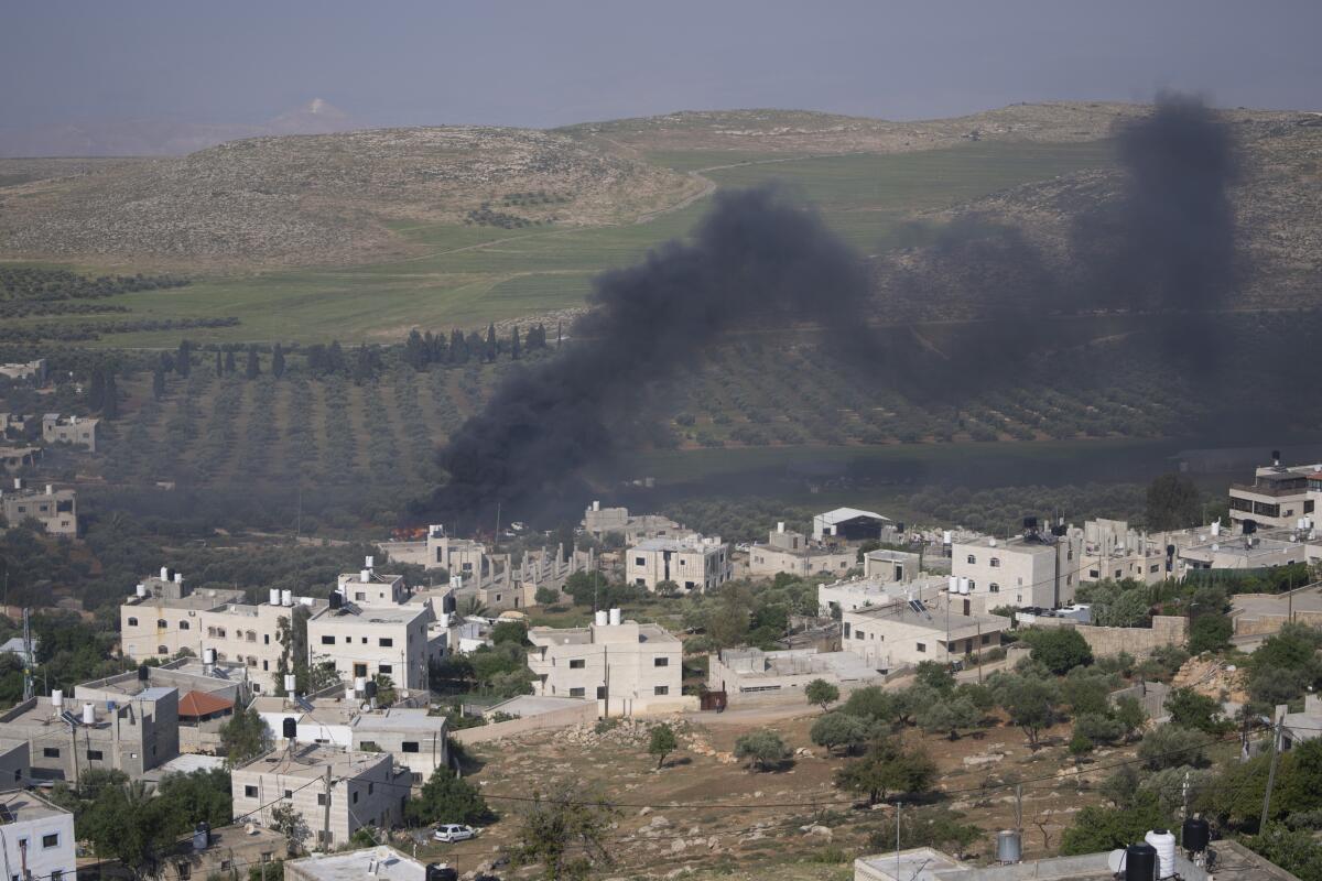 Smoke fills the sky after Israeli settlers burn homes in Palestinian villages in the West Bank.