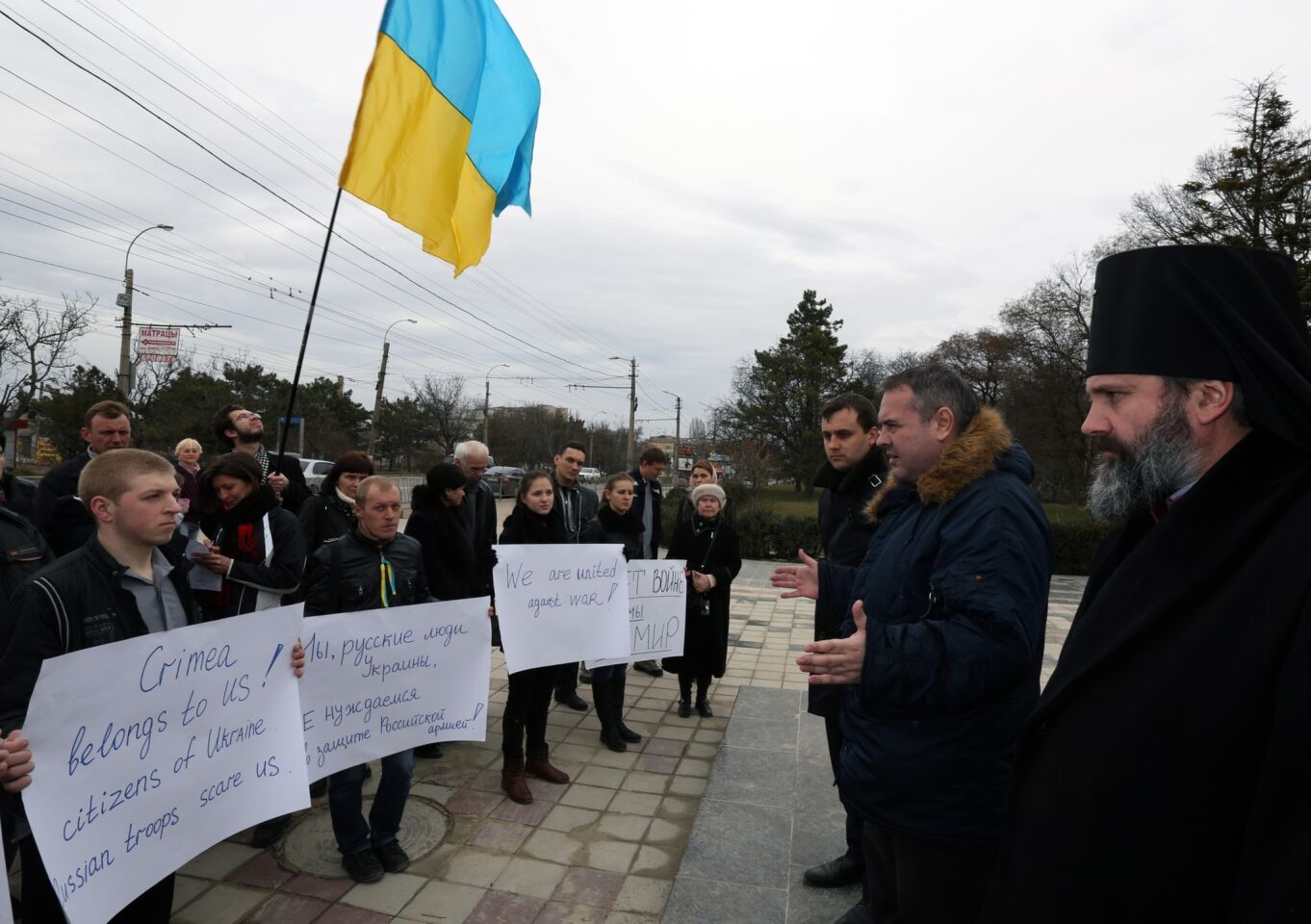Demonstrators rally in Simferopol, a city in Ukraine's Crimea region. One of their signs says, "Crimea belongs to us! Citizens of Ukraine. Russian troops scare us." Another says, "We are united against war!"