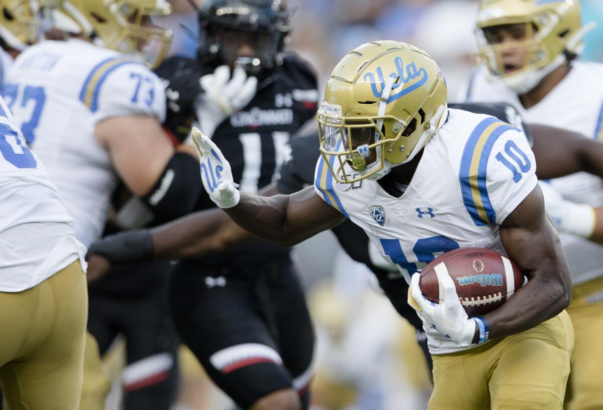 UCLA running back Demetric Felton carries the ball during the first half of the Bruins' 24-14 season-opening loss to Cincinnati on Thursday.