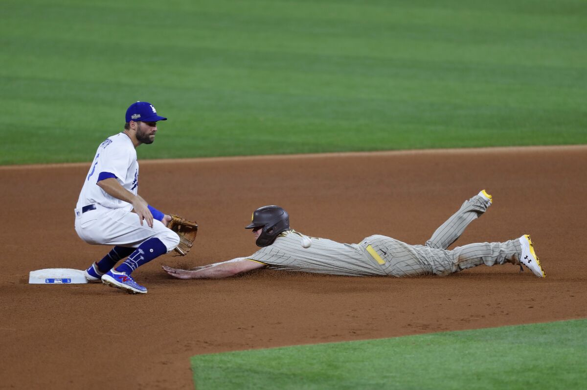 Wil Myers of the Padres steals second bases as the Dodgers' Chris Taylor fields during Game 1 of the NLDS at Globe Life Field
