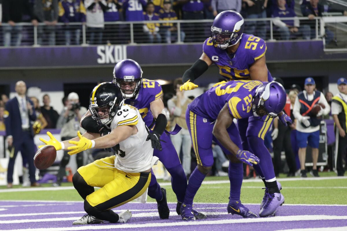 Minnesota Vikings defenders safety Harrison Smith (22), outside linebacker Anthony Barr (55) and free safety Xavier Woods (23) break up a pass intended for Pittsburgh Steelers tight end Pat Freiermuth (88) in the end zone at the end of an NFL football game, Thursday, Dec. 9, 2021, in Minneapolis. The Vikings won 36-28. (AP Photo/Andy Clayton-King)