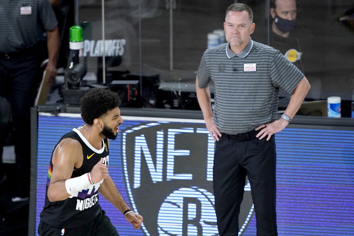 Denver Nuggets' Jamal Murray, left, reacts near head coach Michael Malone after a play against the Utah Jazz during the second half of an NBA basketball first round playoff game, Monday, Aug. 17, 2020, in Lake Buena Vista, Fla. (AP Photo/Ashley Landis, Pool)