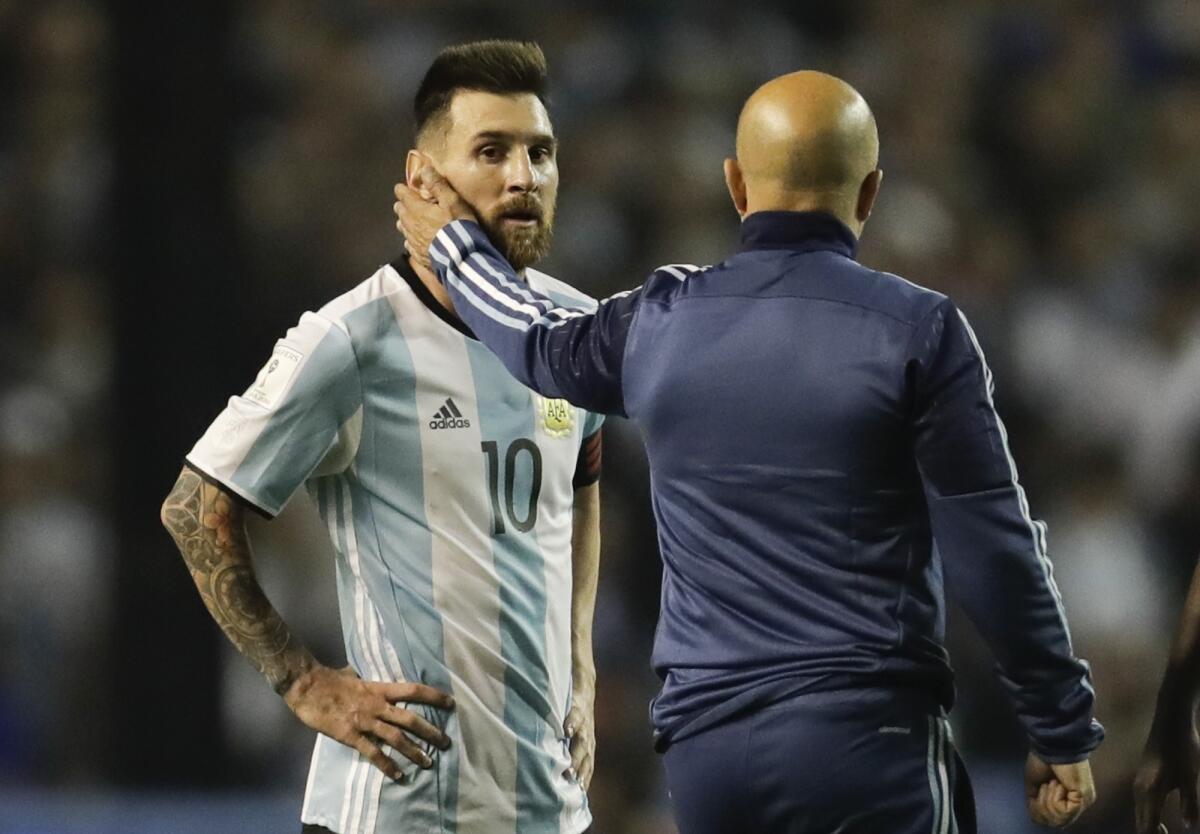 Argentina's Lionel Messi, left, is comforted by Argentina coach Jorge Sampaoli after a World Cup qualifying soccer match at La Bombonera stadium in Buenos Aires, Argentina, Thursday, Oct. 5, 2017. Argentina tied the match 0-0 and is almost eliminated from the upcoming World Cup in Russia.