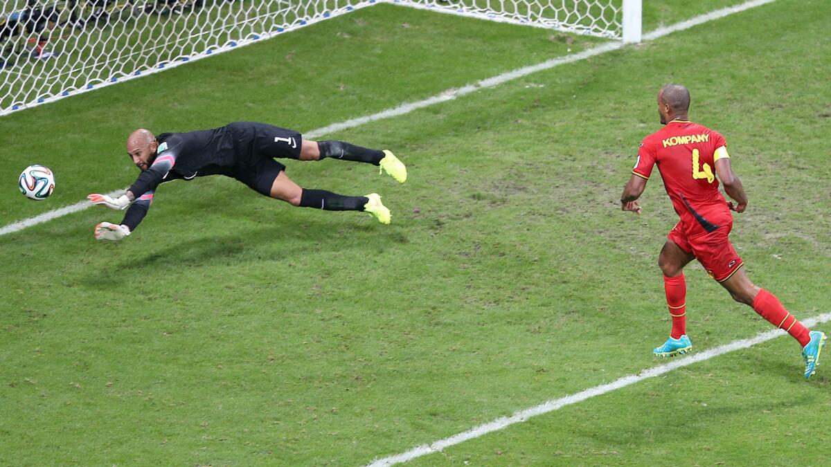 U.S. goalkeeper Tim Howard deflects a shot by Belgium's Vincent Kompany during the USA's 2-1 World Cup loss Tuesday. Howard made 16 saves in the loss.