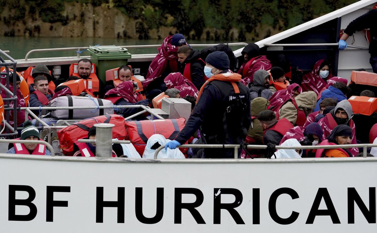A group of people thought to be migrants are brought in to Dover, Kent, onboard a Border Force vessel, following a small boat incident in the English Channel, Monday May 2, 2022. Hundreds of people have crossed the English Channel in small boats in the last 24 hours, British officials said Monday, after more than a week in which no crossings were reported. The Ministry of Defense said 254 people arrived on the English coast in seven boats from northern France on Sunday, and more people were brought ashore by British lifeboats on Monday. (Gareth Fuller/PA via AP)