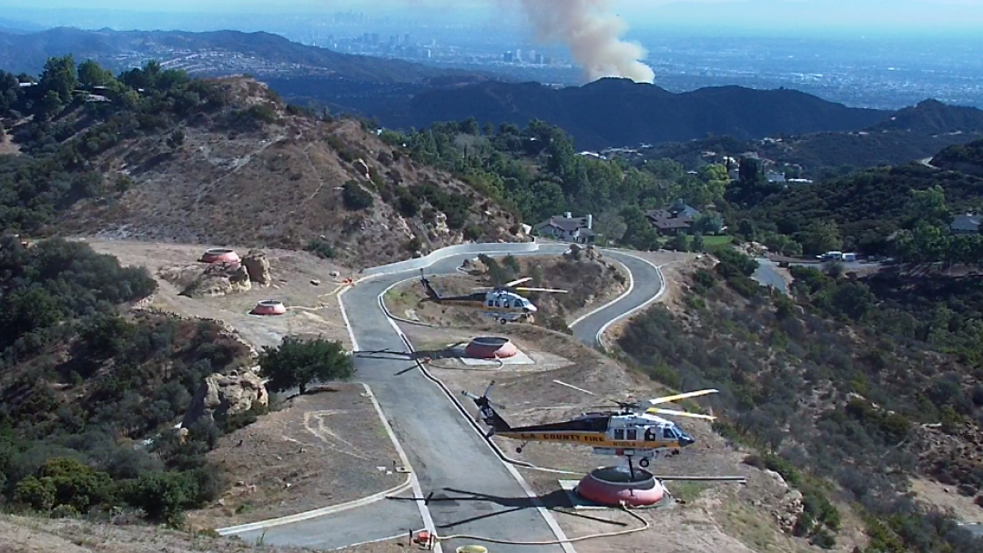 Los Angeles County Fire Department helicopter refilling with water during the Palisades Fire on Oct. 21.