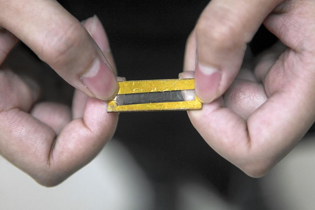 This capacitor created by UC Irvine researchers led by Mya Le Thai has three key components: a gold nanowire, an inorganic compound known as manganese dioxide and a Plexiglas-like gel. It is 2 inches long and about a quarter-millimeter thick.