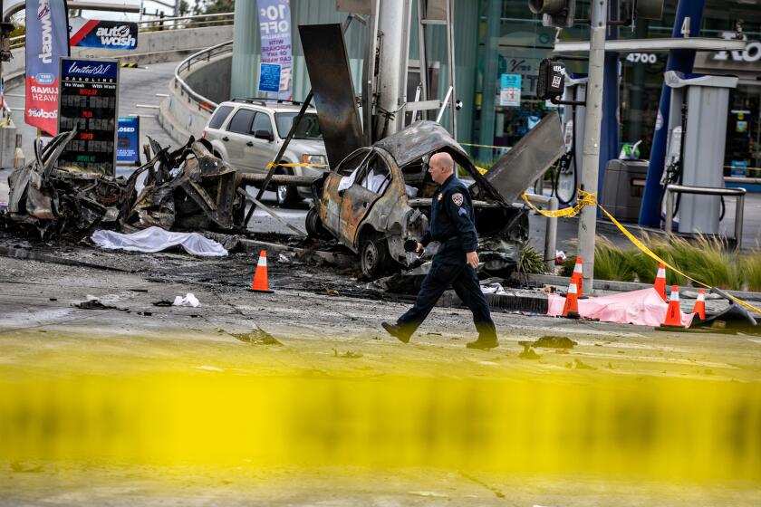 LOS ANGELES, CA - AUGUST 04: CHP and other officials investigate a fiery crash where multiple people were killed near a Windsor Hills gas station at the intersection of West Slauson and South La Brea avenues on Thursday, Aug. 4, 2022 in Los Angeles, CA. (Jason Armond / Los Angeles Times)