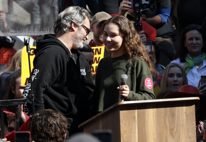 Joaquin Phoenix introduces Nalleli Cobo during a City Hall protest Friday.