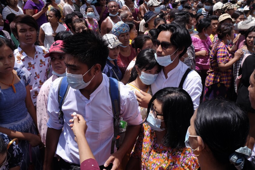 Zay Yar Lwin, center left in white, and Paing Pyo Min,center right in white, – both members of the Peacock Generation, a traditional theatrical troupe sentenced to prison in 2019 for their gibes about the military, walk through a crowd after their release from Insein prison in Yangon, Myanmar, Saturday, April 17, 2021. Myanmar's junta on Saturday announced it pardoned and released more than 23,000 prisoners to mark the new year holiday, but it wasn't immediately clear if they included pro-democracy activists who were detained in the wake of the February coup. (AP Photo)