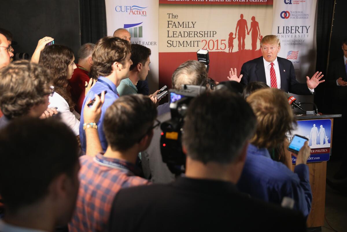 Republican presidential hopeful Donald Trump fields questions from the media at the Family Leadership Summit at Stephens Auditorium in Ames, Iowa.