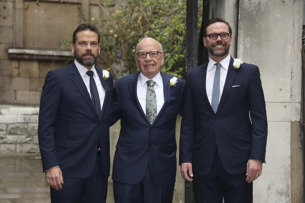  From left, Lachlan Murdoch, Rupert Murdoch and James Murdoch arrive at a church.