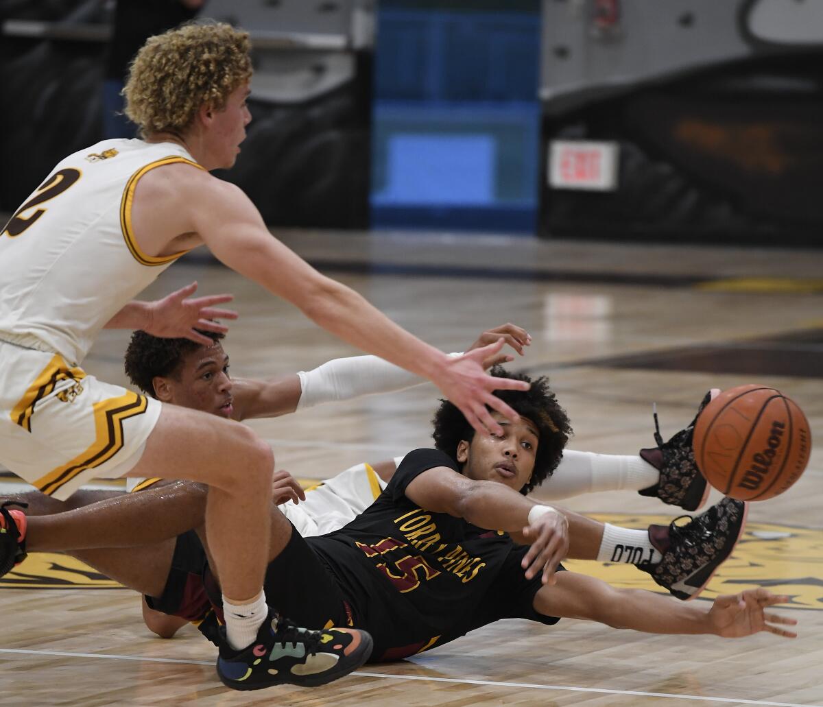 Torrey Pines' Chris Howell passes off in front of El Camino's Henry Hartwell.