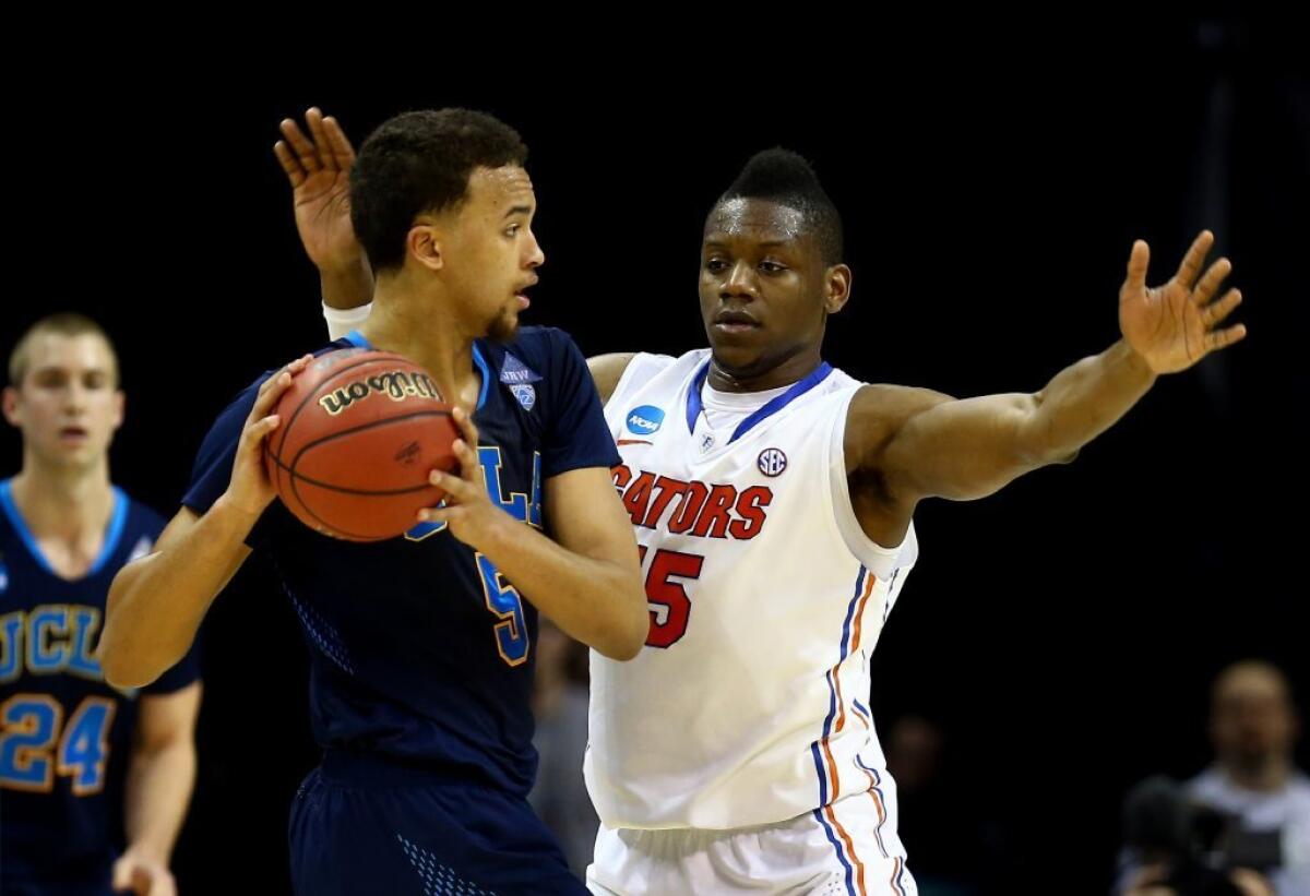 Florida's Will Yeguete guards UCLA's Kyle Anderson on March 27.