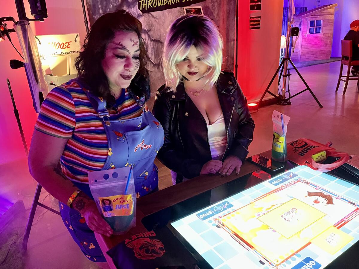 Partygoers at Thriller Nights play touchscreen game-table versions of classic board games.