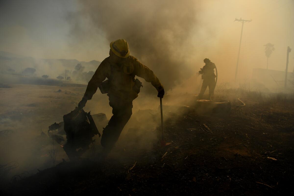 Fire fighters battle a brush fire 