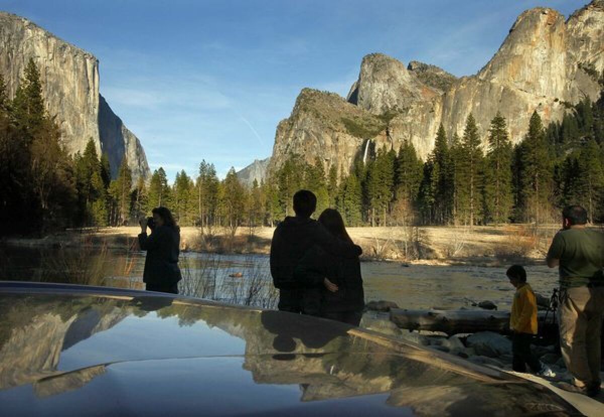 Visitors to the park stop to look, photograph and enjoy the light and scenery of the Yosemite Valley on a cool spring evening.