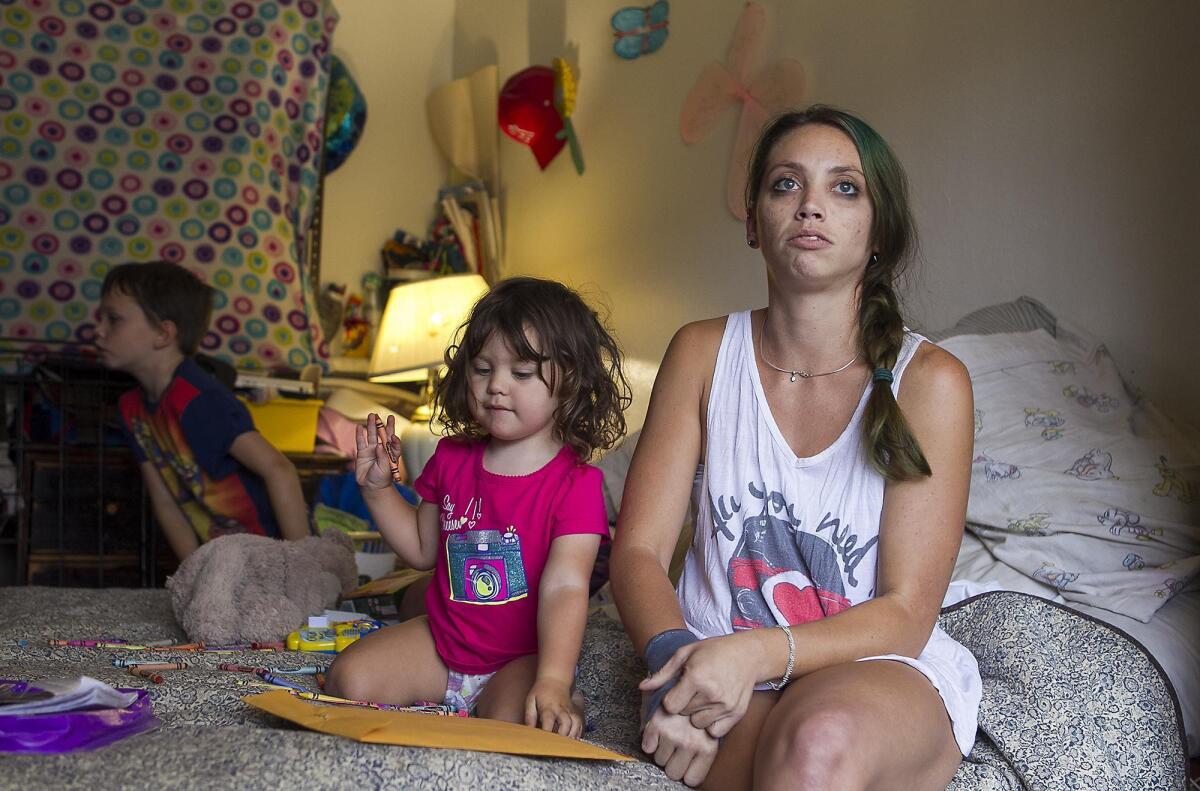 Amanda Haupert and her children Joey, center, and Scott are long-term residents at the Costa Mesa Motor Inn on Harbor Boulevard. Haupert and her husband don’t yet have a home secured for the family once they leave the Motor Inn, which is slated to close soon.