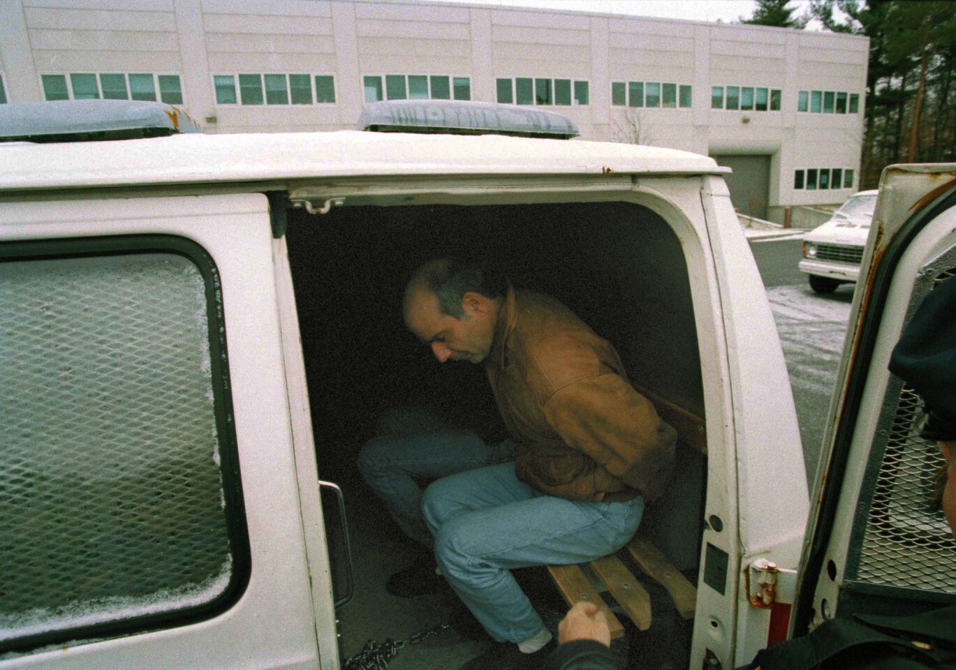 John Esposito sits handcuffed in a van in Hauppauge, N.Y., as he is about to be taken to court for arraignment on charges of kidnapping Katie Beers.