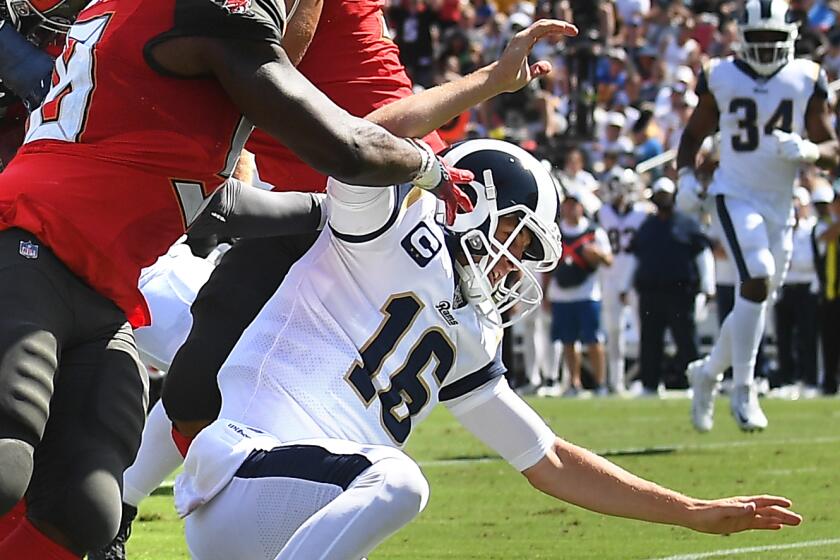 LOS ANGELES, CALIFORNIA SEPTEMBER 29, 2019-Rams quarterback Jared Goff (16) falls to the ground as Bucaneers linebacker Lavonte David, left, is tackeled after intercepting the ball in the 2nd quarter at the Coliseum Sunday. (Wally Skalij/Los Angeles Times)