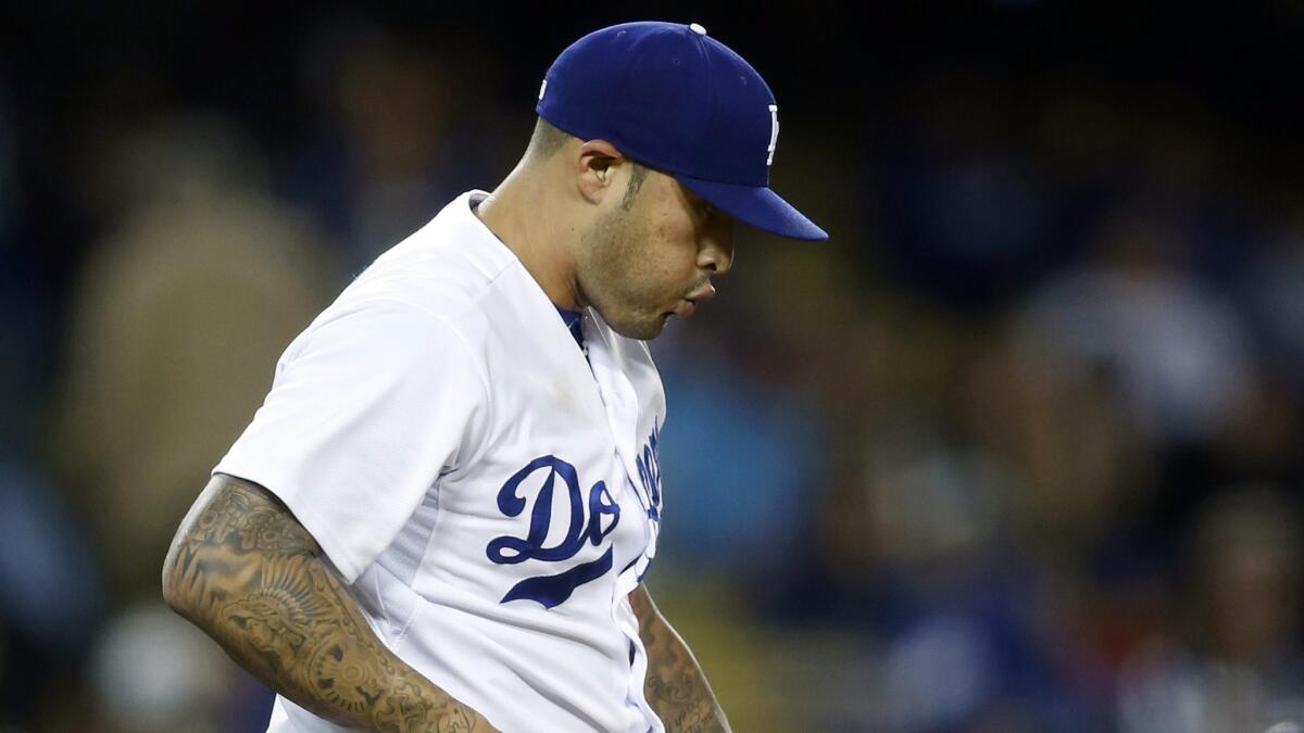 Former Dodgers reliever Sergio Santos reacts after giving up a two-run home run to Colorado's Nolan Arenado on May 16.