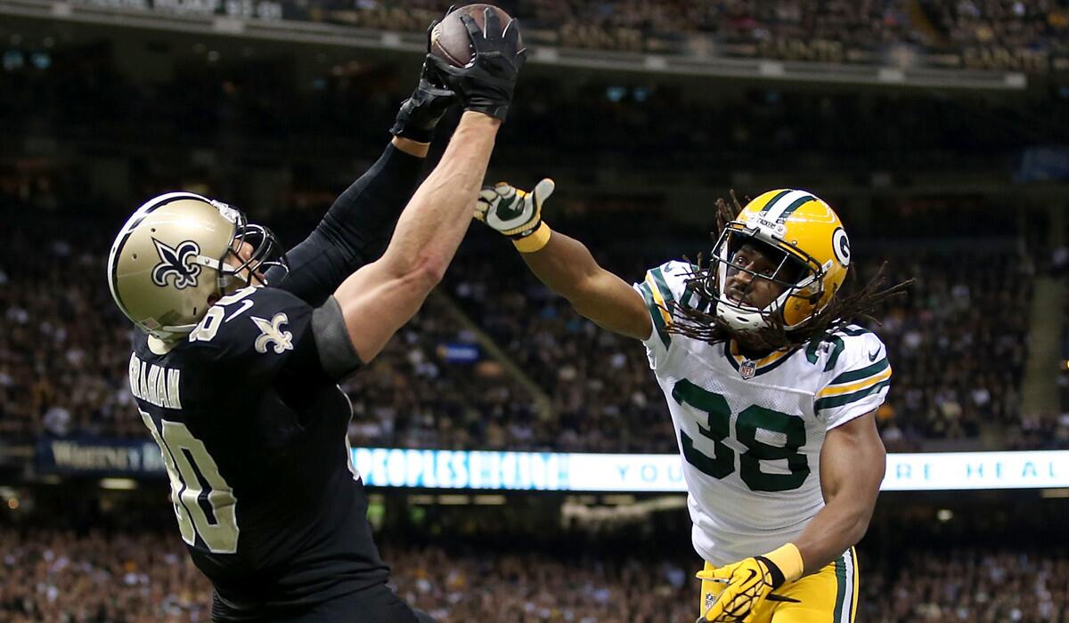 Packers defensive back Tramon Williams can't prevent Saints tight end Jimmy Graham from making a touchdown catch Sunday evening in New Orleans.