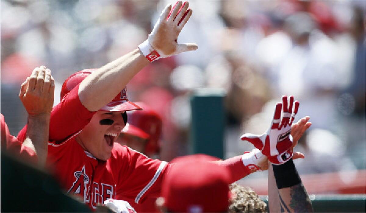 Mike Trout celebrates with his Angels teammates after hitting his first career grand slam Saturday against Detroit.
