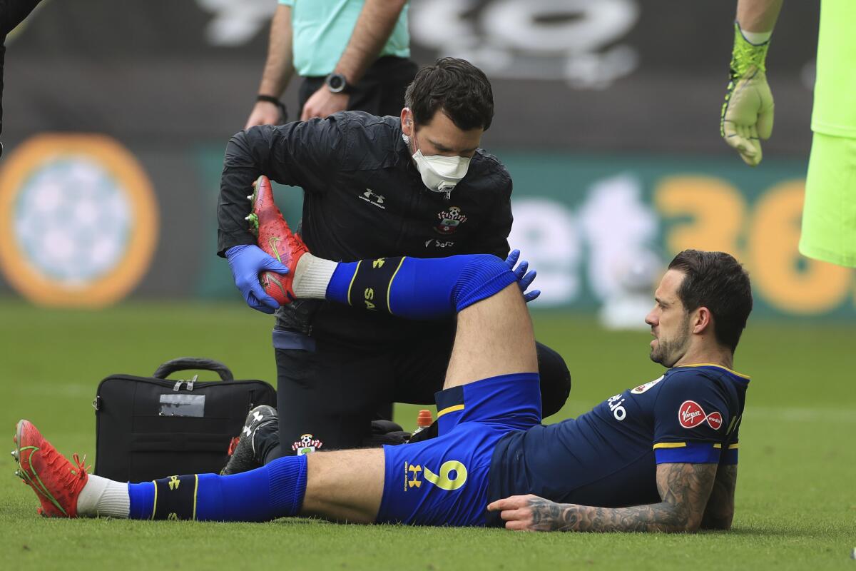 Southampton's Danny Ings is treated after getting injured during an English Premier League soccer match between Sheffield United and Southampton at the Bramall Lane stadium in Sheffield, England, Saturday March 6, 2021. (Mike Egerton/Pool via AP)