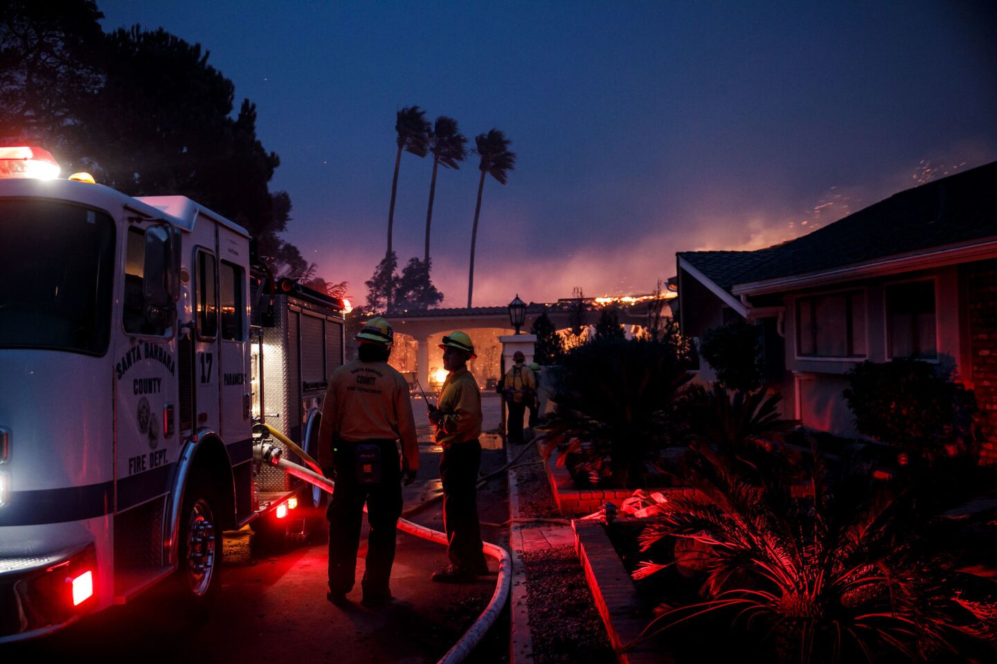 Firefighters are deployed to battle the fire in a Ventura neighborhood.