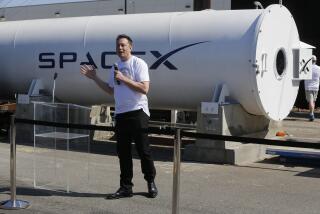 Telsa CEO Elon Musk congratulates the winners of the Hyperloop Pod Competition II at SpaceX's Hyperloop track in Hawthorne, Calif., Sunday, Aug. 27, 2017. The Hyperloop system built by SpaceX is approximately one mile in length with a six-foot outer diameter. The WARR team from Tech University Munich won the Hyperloop Pod Competition II with a peak speed of 324 kilometers per hour (201 mph). (AP Photo/Damian Dovarganes)