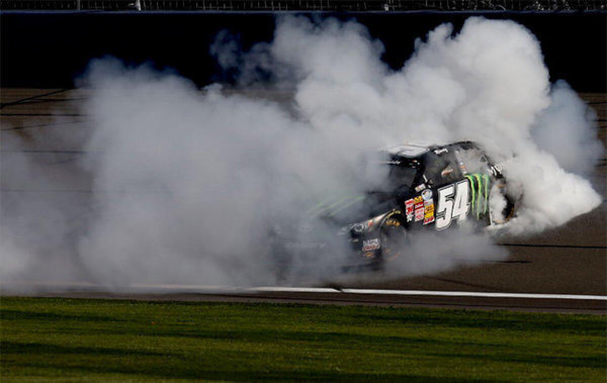 Kyle Busch does a burnout after winning the NASCAR Nationwide Series Royal Purple 300 at Auto Club Speedway.