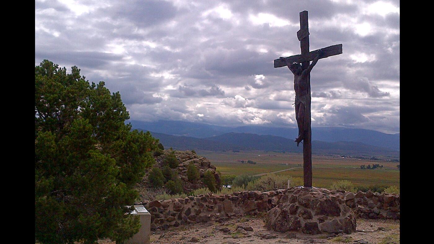 The Stations of the Cross Shrine is a half-mile walk that passes 15 stations featuring the death and resurrection of Jesus Christ. The final station stands atop a hill beside La Capilla de Todos Los Santos, or the Chapel of All Saints. This is Station 12 - the Crucifixion.