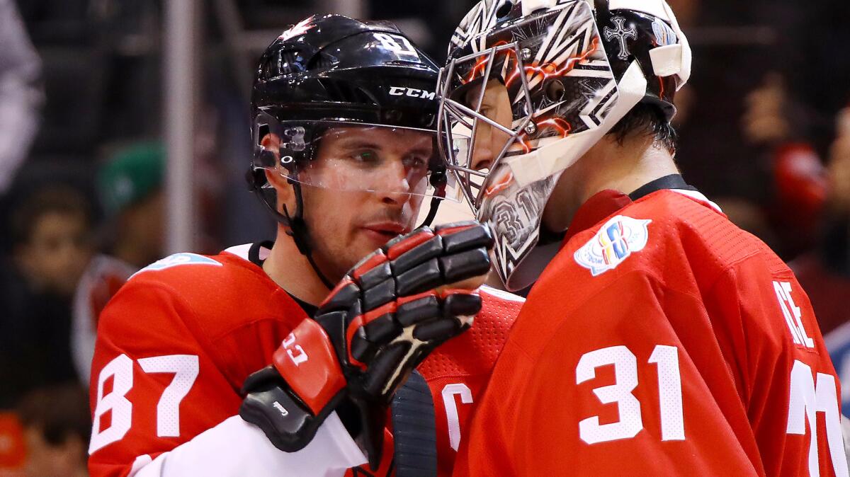 Team Canada captain Sidney Crosby (87) congratulates goalie Carey Price after their Game 1 victory over Team Europe on Tuesday.