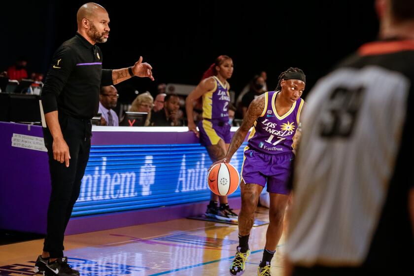 LOS ANGELES, CA. - JUNE 30: Derek Fisher, Head Coach of the Sparks, watches as point guard Erica Wheeler runs the play he drew up against the Las Vegas Aces at the Los Angeles Convention Center on Wednesday, June 30, 2021 in Los Angeles, CA. (Jason Armond / Los Angeles Times)