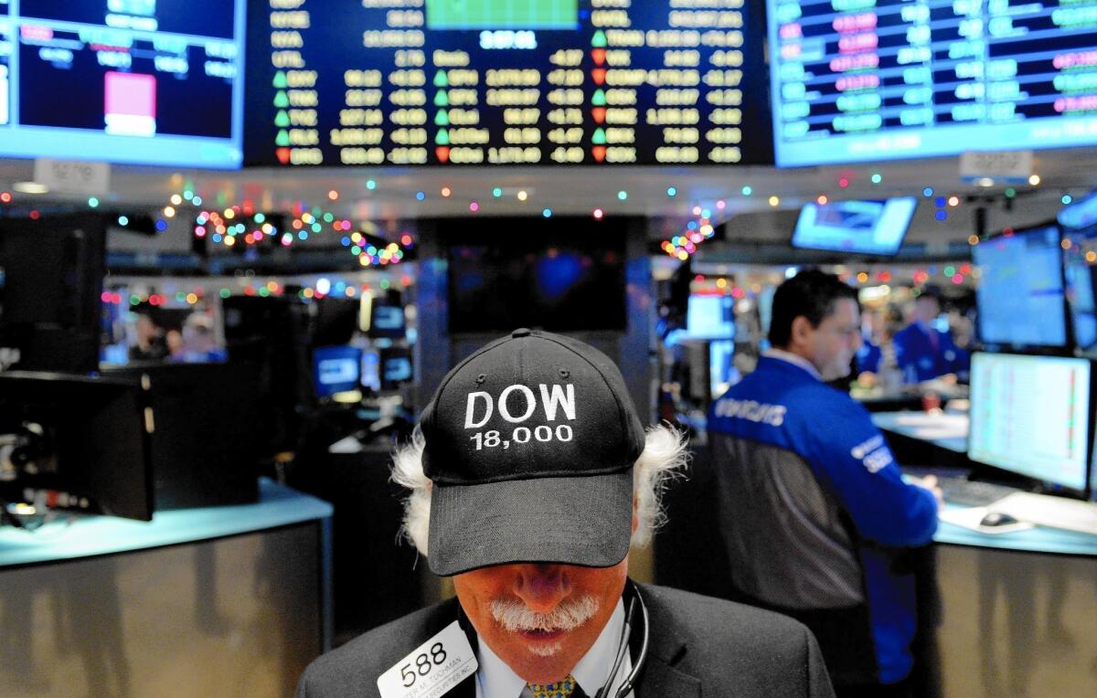 A trader wears a "Dow 18,000" hat on the floor of the New York Stock Exchange on Tuesday.