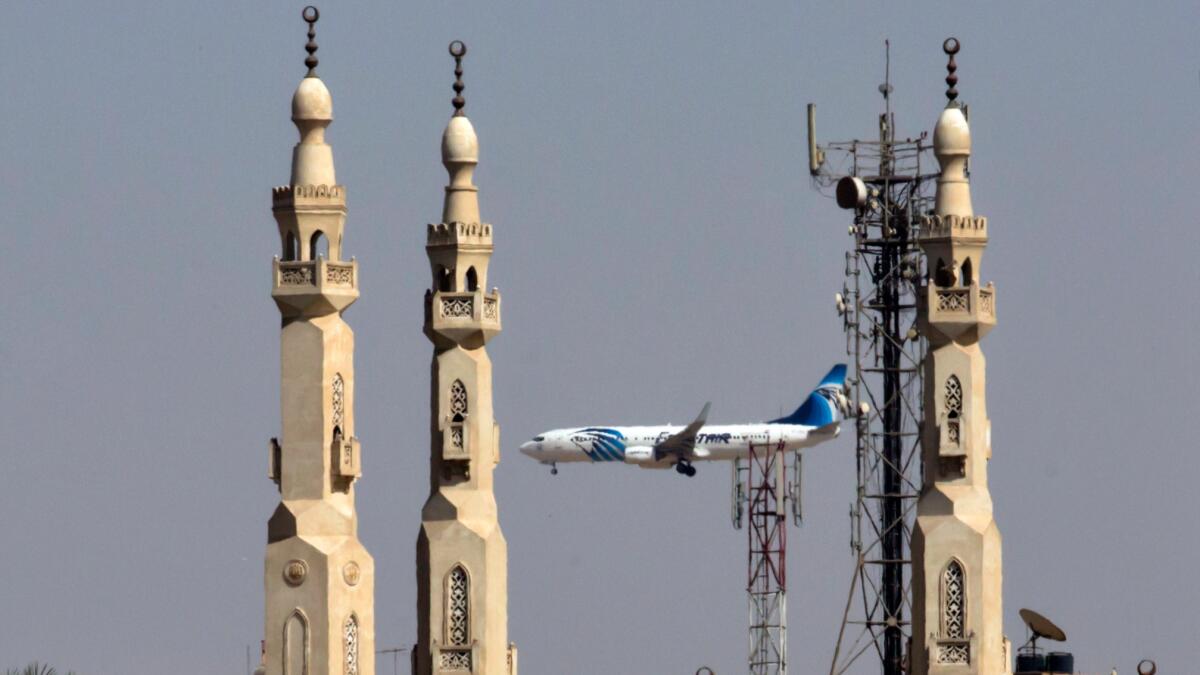 An EgyptAir plane approaches Cairo International Airport.